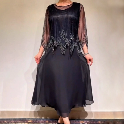 Elegancka sukienka w jednolitym kolorze z połyskującą, prześwitującą nakładką